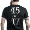 Man wearing black Trump 45 47 Victory T-Shirt - Unisex MAGA patriot graphic tee celebrating Trump's historic terms - White logo on back