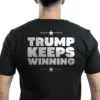 Man wearing black Trump Keeps Winning T-shirt – Unisex unstoppable MAGA patriotic graphic tee